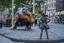 The Fearless Girl statue faces the Charging Bull on Wall Street.